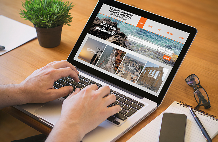 Person using laptop to visit Booking.com