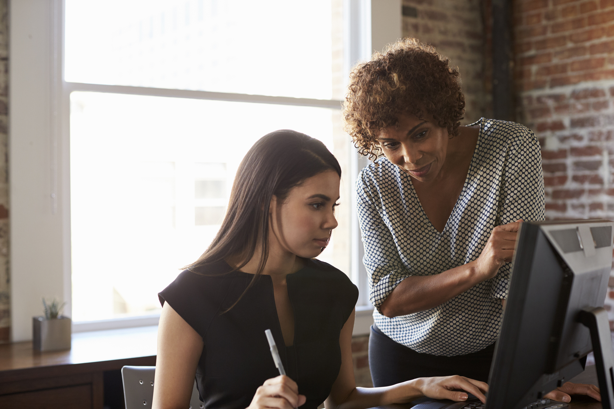 Summer Internships: Intern Receiving Help at Computer