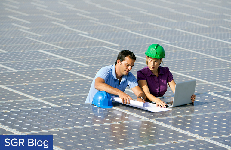 Solar Power: Technicians work on solar panels