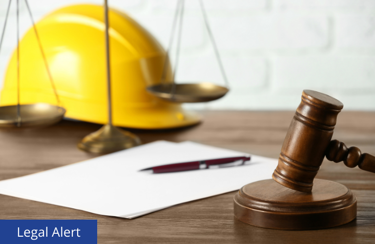 Picture of a construction hat behind a gavel.